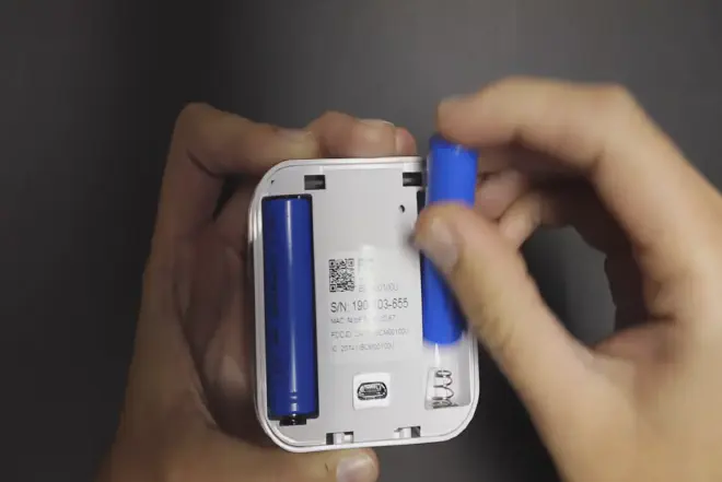 An illustrative guide to blink replace battery, including the proper positioning of the new battery and the method for securing it in place.